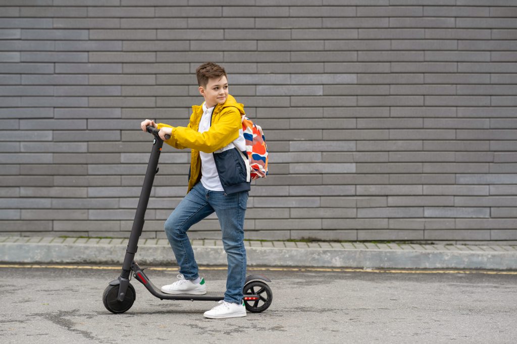 modernteenageronelectricscooter-ecologicaltransportconcept