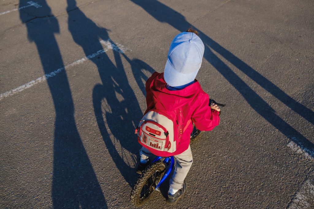 activeblondkidboydrivingbicycleinthepark-toddler-2